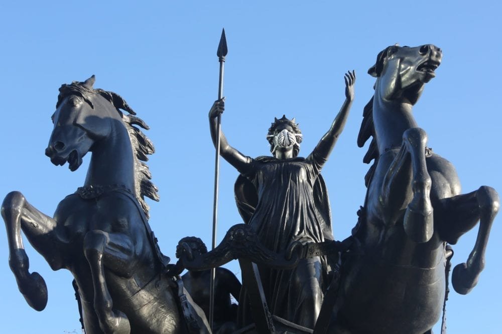 Greenpeace activists fit the Boudica statue at Westminster Bridge with an emergency face mask to demand action on air pollution.