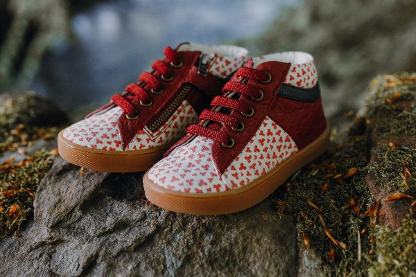 Woodland shot of Pip and Henry ethical kids' shoes, with a red clover design