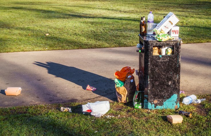 Overflowing bin in public park