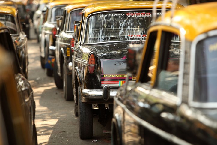 Mumbai taxi cars lined up on a busy downtown street