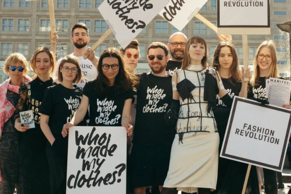 Fashion Revolution activists in Berlin, holding boards reading 'Who Made My Clothes?'