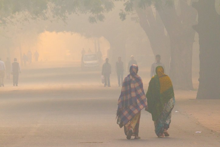 Two women walking in extreme smog in New Delhi