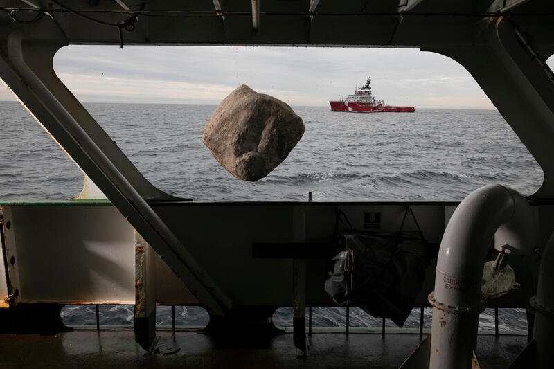 View from the MY Esperanza as a boulder falls into the English channel from the Greenpeace ship