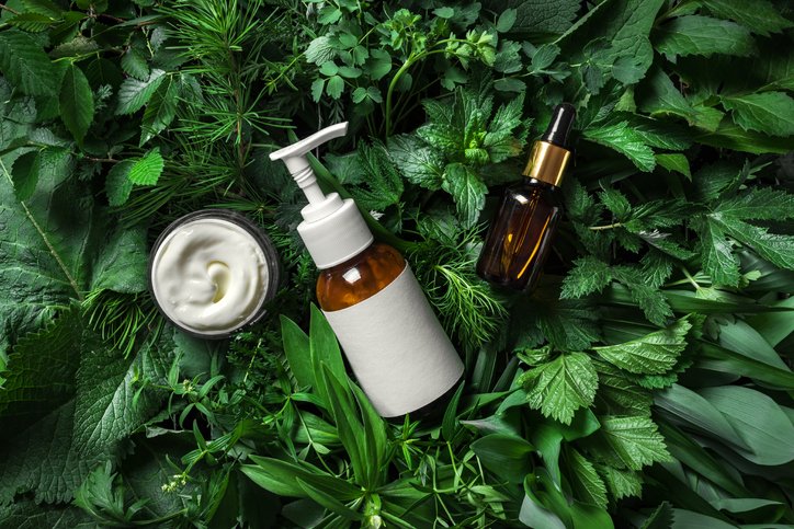 Cosmetic skin care products on green leaves