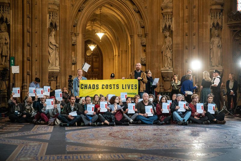 Dozens of climate and fuel poverty activists occupy a hall at the heart of Parliament to tell the government: Chaos costs lives.
