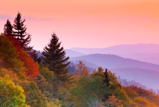 Sunrise over mountains and forests in autumn