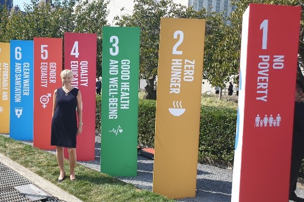 Helena Lindemark outside the SDG banners a the UN HQ in New York