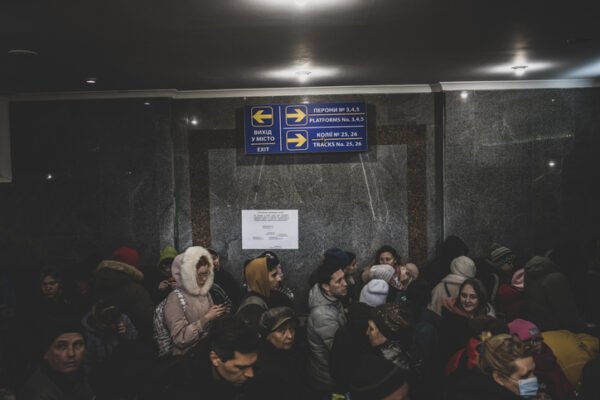 A long line of people wait to board a train to Poland in Lviv, Ukraine