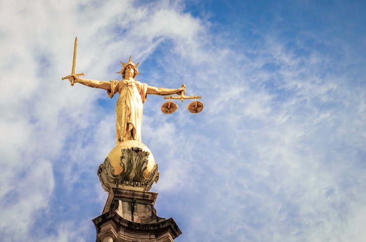 The statue of Lady Justice, holding a sword and weighing scales, located on top of the Central Criminal Court (Old Bailey) in London