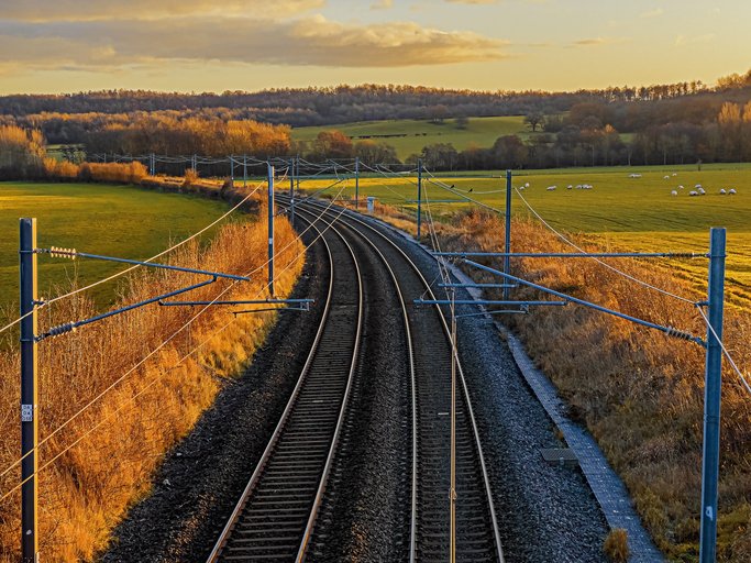 View of a railway line in the English countryside. Station on a bright day in late summer