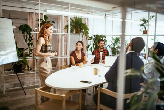 Businesswoman in office with colleagues, having presentation of business results