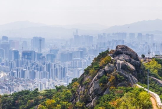 The city walls on top of Inwangsan mountain peak looking out over the crowded cityscape of Seoul, South Korea