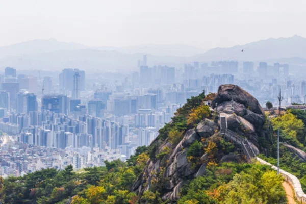 The city walls on top of Inwangsan mountain peak looking out over the crowded cityscape of Seoul, South Korea