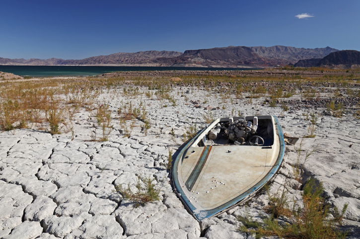 An abandoned boat on the shores of Lake Mead near Las Vegas, Nevada. Like many artifacts, ruins, and even bodies, this boat has now come to light as the shore of Lake Mead is significantly receding
