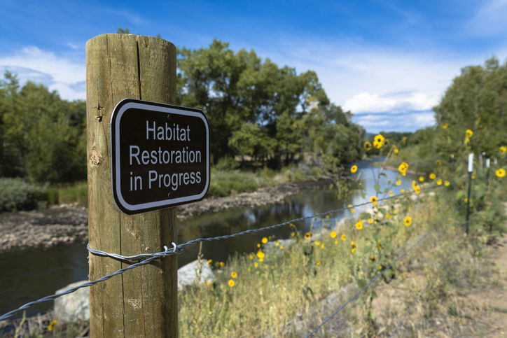 A Habitat Restoration in Progress sign
