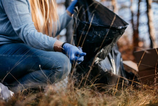 Teenagers collecting garbage in the nature