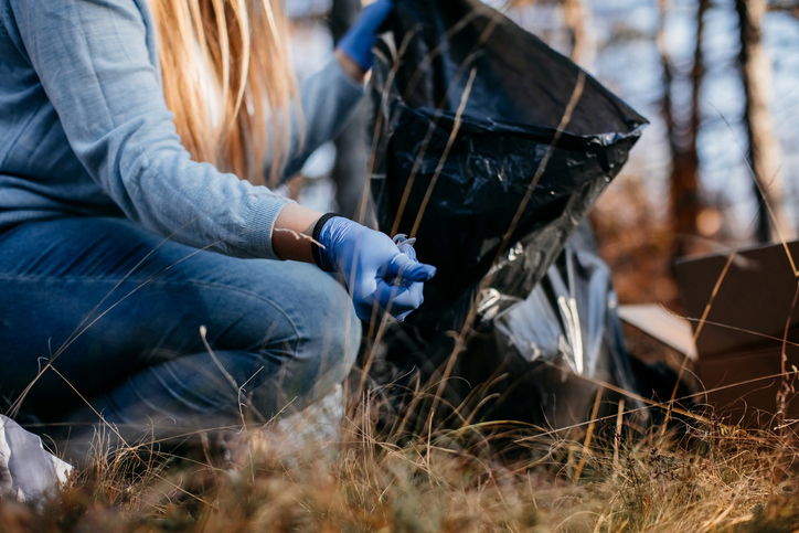 Teenagers collecting garbage in the nature