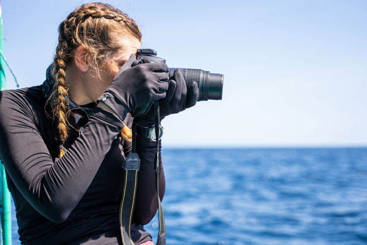 Profile of a female marine biologist talking photos in the sea