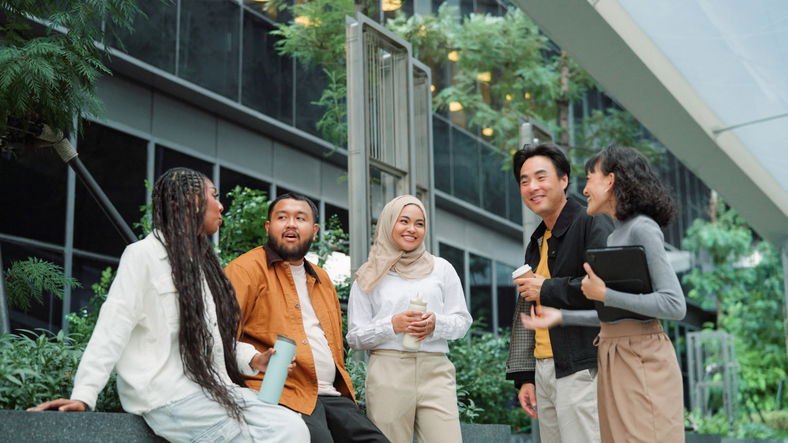 Asian business team taking a break and relaxing at green office