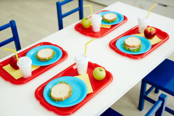 preschool lunch table, set with plates of white sandwiches
