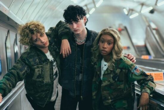 Three models wearing Stuart Trevor's designs on the London Underground