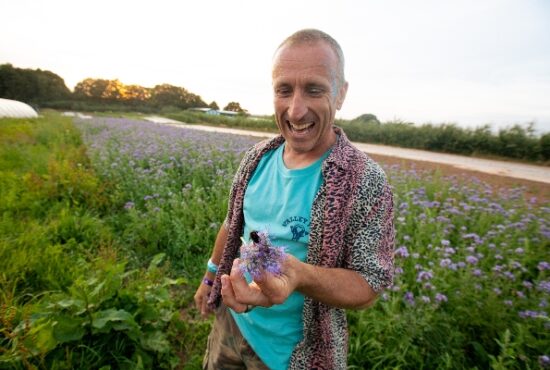 Luke Hassell with a bumble bee at his farm in Somerset